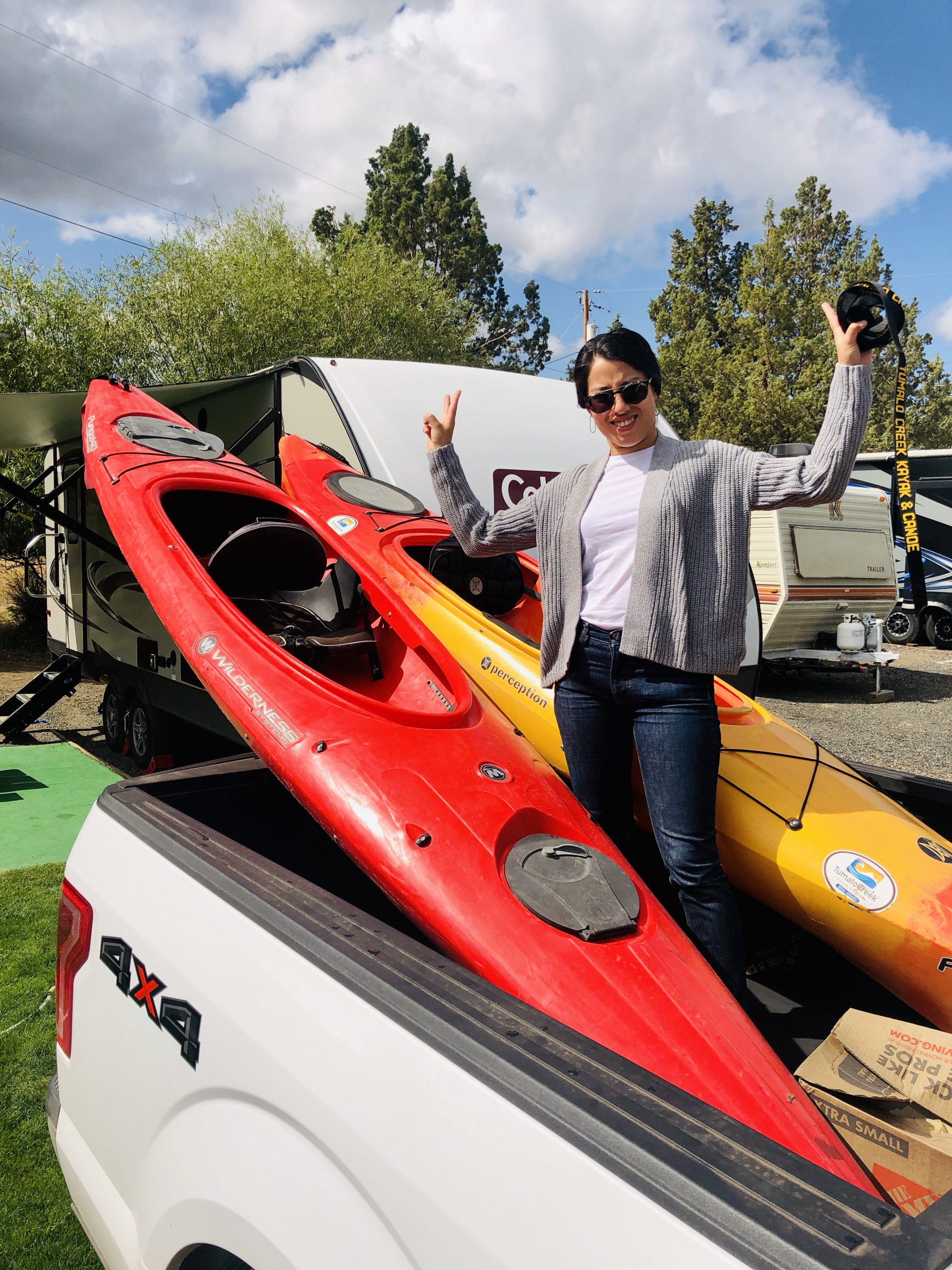 Maribeth in the truck bed with our new kayaks!